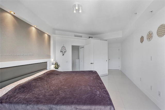 unfurnished bedroom featuring light tile patterned flooring and visible vents