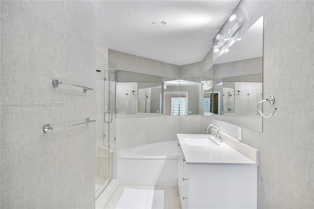 full bathroom featuring tile walls, tile patterned floors, a stall shower, vanity, and a bath