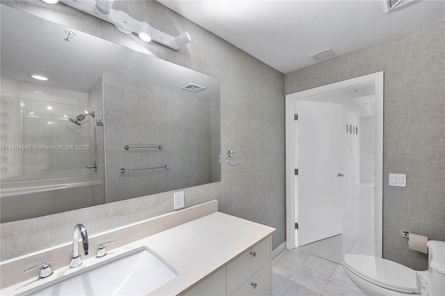 bathroom with toilet, vanity, visible vents, tile patterned floors, and a stall shower