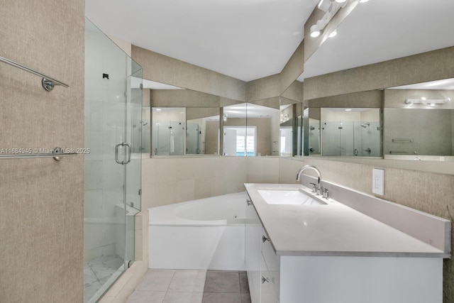 bathroom featuring a garden tub, tile patterned flooring, vanity, tile walls, and a shower stall