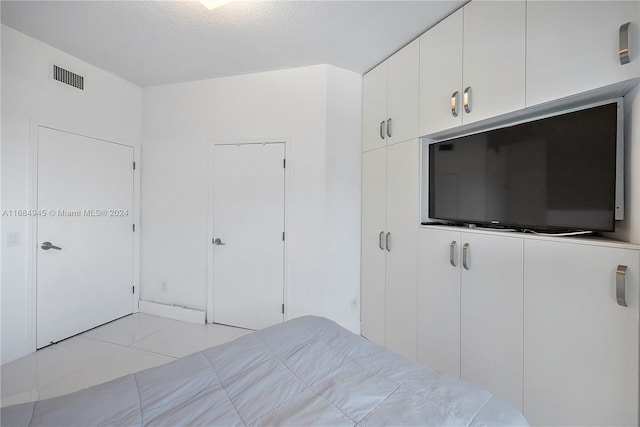 unfurnished bedroom with light tile patterned floors and a textured ceiling