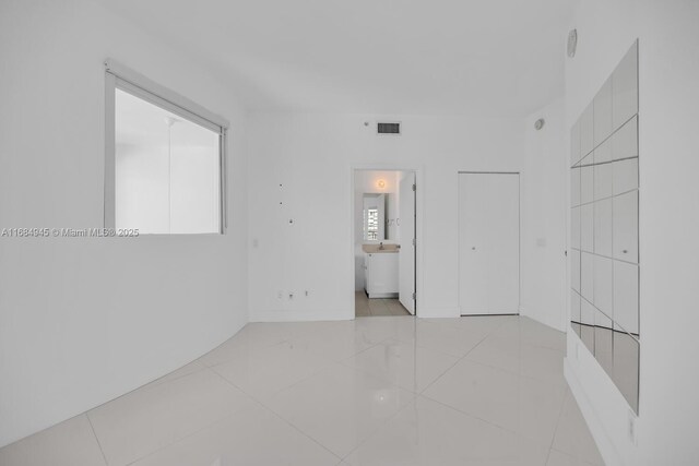 tiled dining space featuring a high ceiling