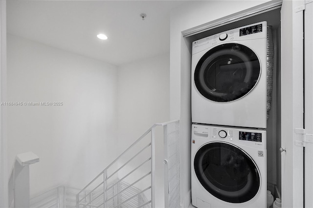 clothes washing area featuring laundry area, stacked washing maching and dryer, and recessed lighting