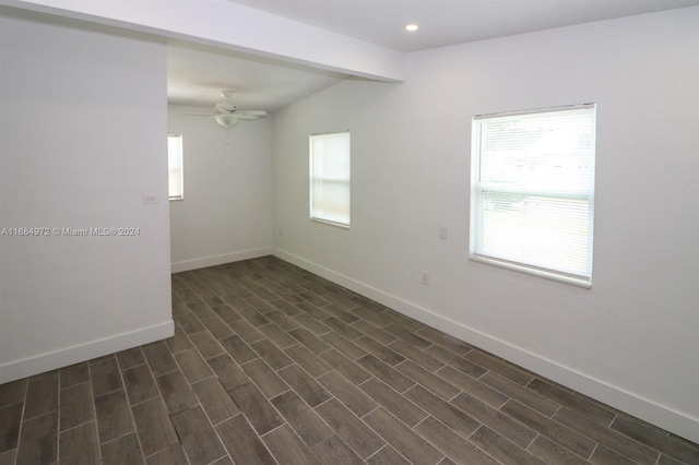 unfurnished room with dark hardwood / wood-style floors and ceiling fan