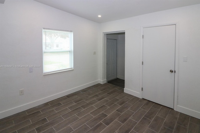 unfurnished bedroom featuring dark hardwood / wood-style floors