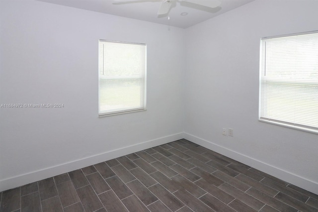 unfurnished room featuring ceiling fan and dark hardwood / wood-style floors