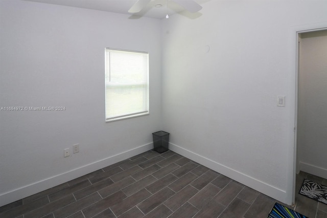 empty room with ceiling fan and dark hardwood / wood-style flooring