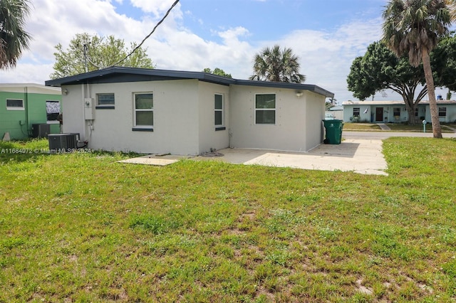 back of property featuring a yard, a patio, and central air condition unit