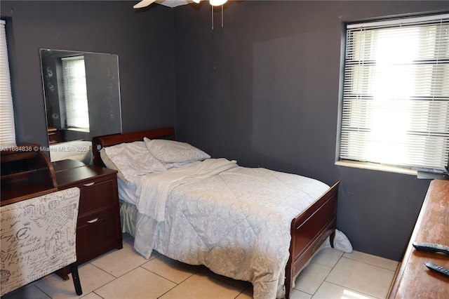 bedroom with ceiling fan and light tile patterned floors