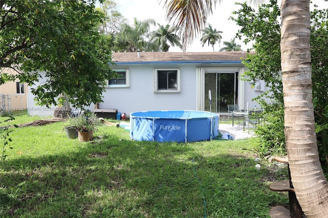 rear view of house with a yard