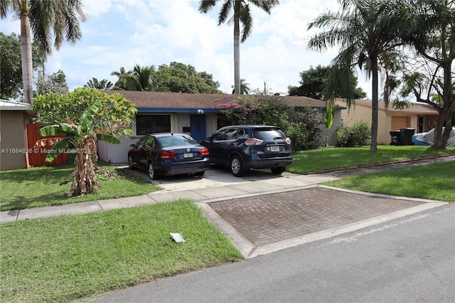 ranch-style home with a front lawn