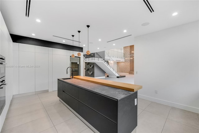 kitchen with white cabinetry, a large island, and pendant lighting