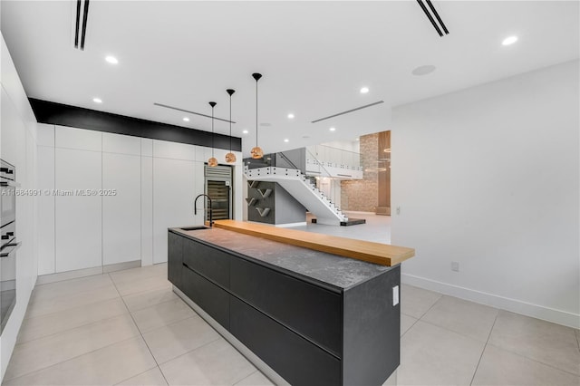 6695 SW 112th St, Pinecrest, FL 33156 - kitchen featuring modern cabinets, a spacious island, light tile patterned floors, and recessed lighting