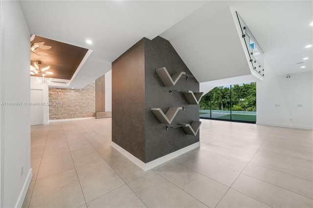 corridor featuring light tile patterned floors and tile walls