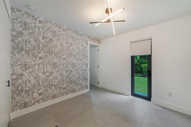 6695 SW 112th St, Pinecrest, FL 33156 - tiled spare room with wallpapered walls, baseboards, a smoke detector, and an accent wall