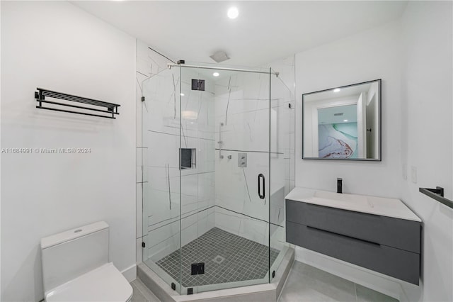 bathroom featuring tile patterned floors, a shower with door, vanity, and toilet