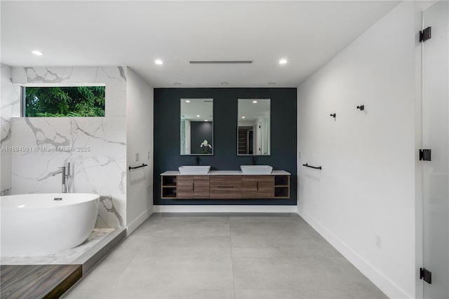 6695 SW 112th St, Pinecrest, FL 33156 - full bathroom with double vanity, a soaking tub, baseboards, concrete flooring, and recessed lighting