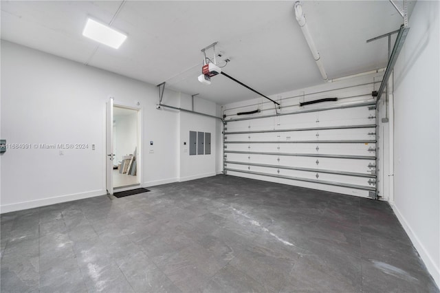 garage featuring electric panel and a garage door opener