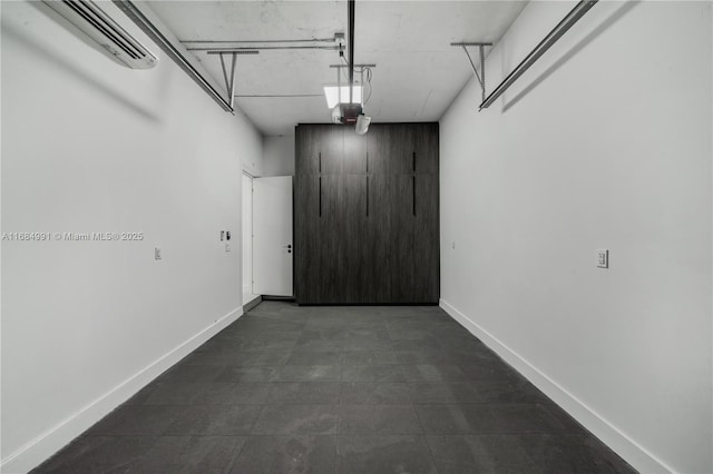 6695 SW 112th St, Pinecrest, FL 33156 - garage with an AC wall unit and baseboards