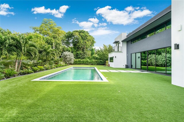 6695 SW 112th St, Pinecrest, FL 33156 - swimming pool with a lawn and a patio area
