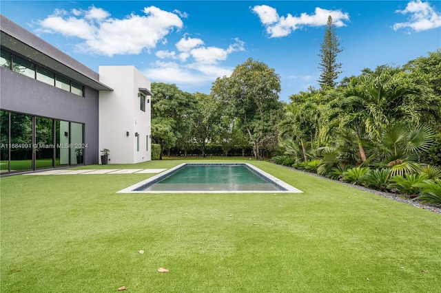 view of swimming pool with a lawn