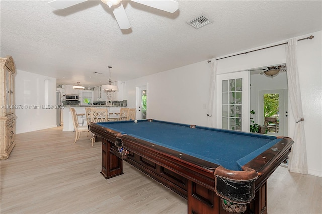 recreation room with ceiling fan, billiards, a textured ceiling, and light hardwood / wood-style flooring