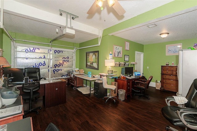 office space with ceiling fan, a textured ceiling, dark hardwood / wood-style flooring, and beamed ceiling