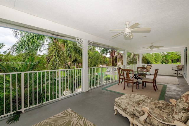 sunroom / solarium featuring ceiling fan