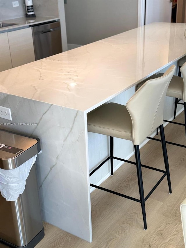 kitchen featuring a breakfast bar and dishwasher