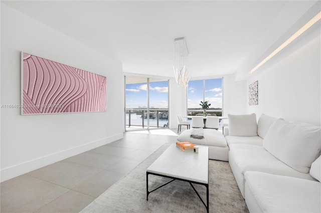 living room with a water view and a wall of windows