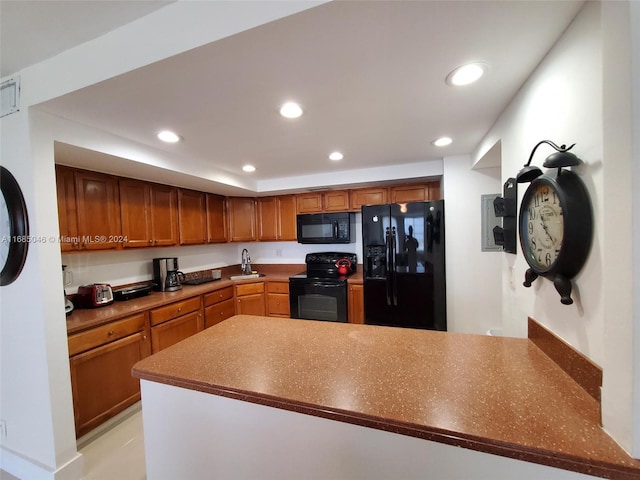 kitchen with black appliances, sink, and kitchen peninsula