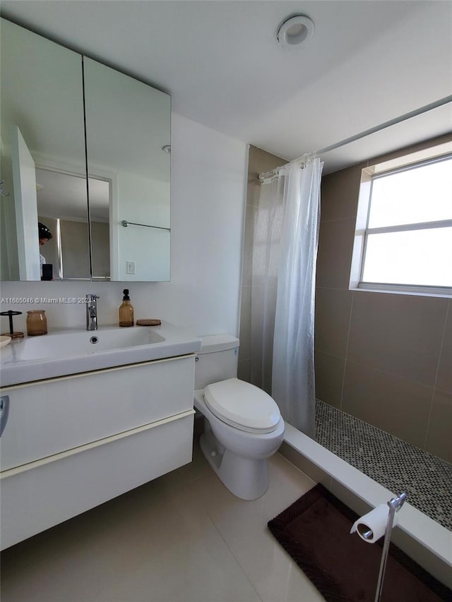 bathroom featuring vanity, toilet, tile patterned floors, and a shower with curtain