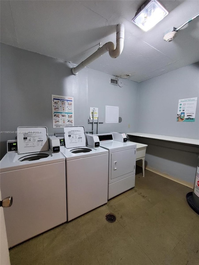 washroom with washing machine and clothes dryer