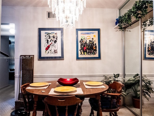 dining space featuring hardwood / wood-style floors, a textured ceiling, and an inviting chandelier