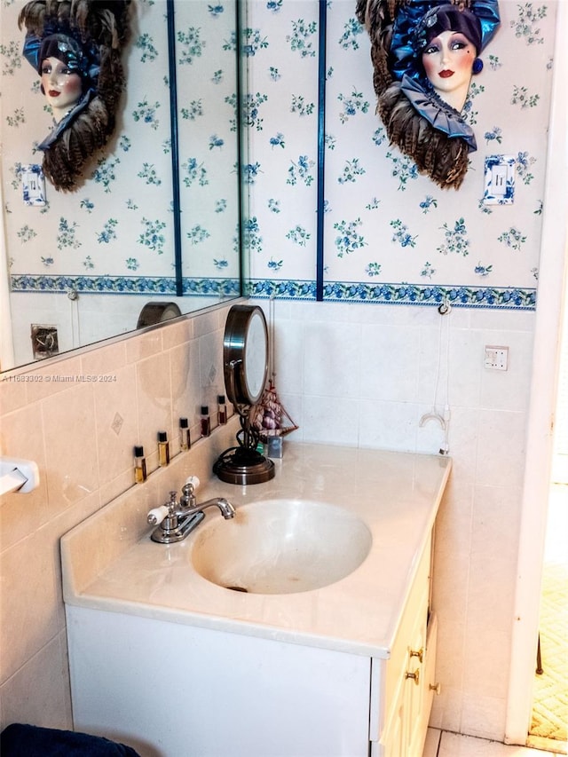 bathroom with vanity and tile walls