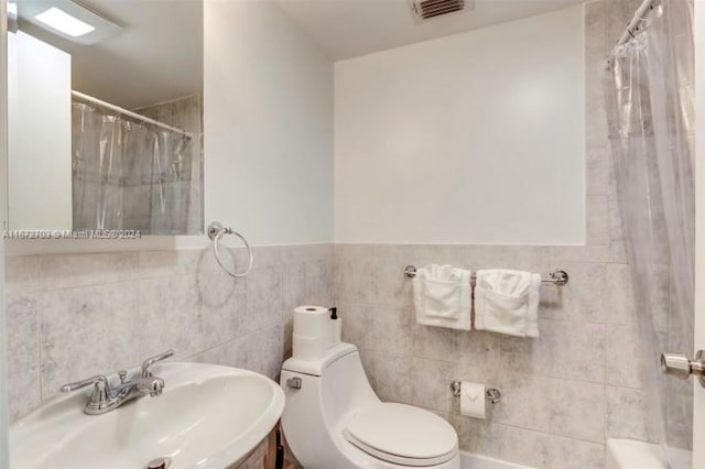 bathroom with vanity, tile walls, curtained shower, and toilet