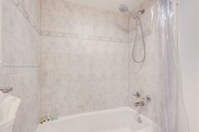 bathroom with shower / bath combination with curtain