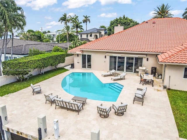 view of swimming pool with a patio and area for grilling