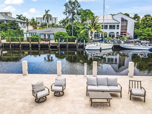 exterior space with a patio area, outdoor lounge area, a water view, and a boat dock