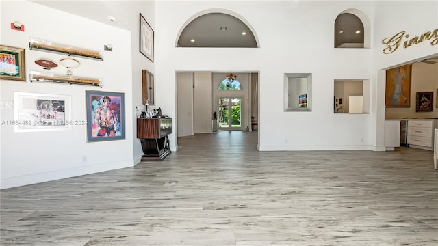 34 Pelican Dr, Fort Lauderdale, FL 33301 - foyer featuring light wood-type flooring, baseboards, and a towering ceiling