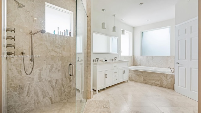 bathroom with vanity and separate shower and tub