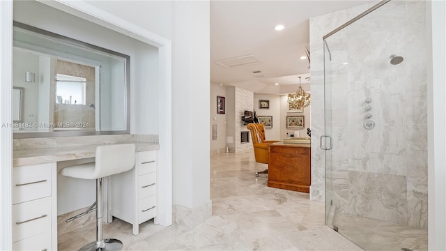 bathroom featuring vanity, a notable chandelier, and walk in shower