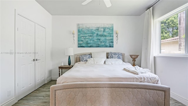 bedroom with a closet, light wood-type flooring, and ceiling fan