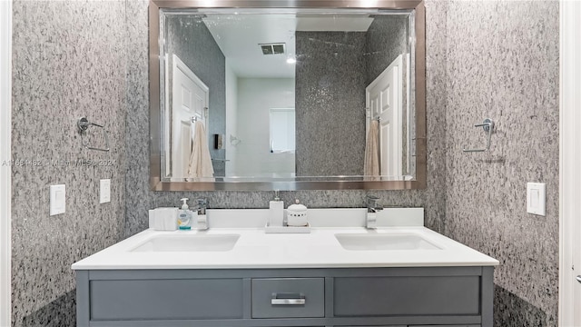 bathroom featuring vanity and tile walls