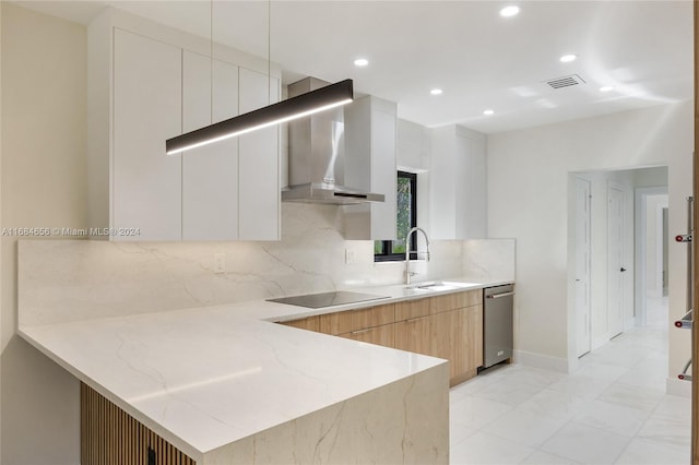 kitchen featuring black electric stovetop, dishwasher, wall chimney exhaust hood, sink, and white cabinets