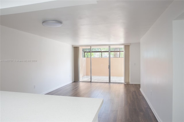 unfurnished room featuring dark hardwood / wood-style floors and floor to ceiling windows