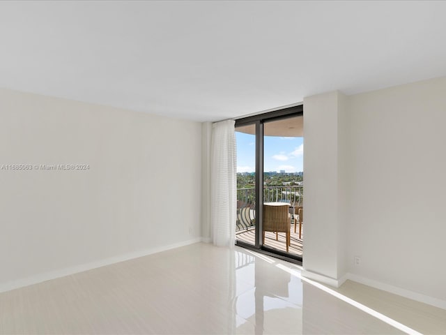 tiled empty room with floor to ceiling windows