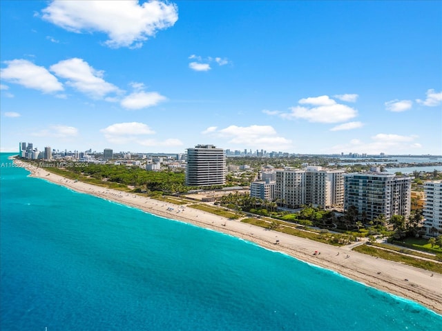 drone / aerial view featuring a water view and a beach view