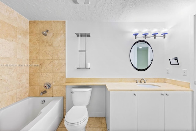 full bathroom featuring tile patterned floors, a textured ceiling, toilet, vanity, and tiled shower / bath