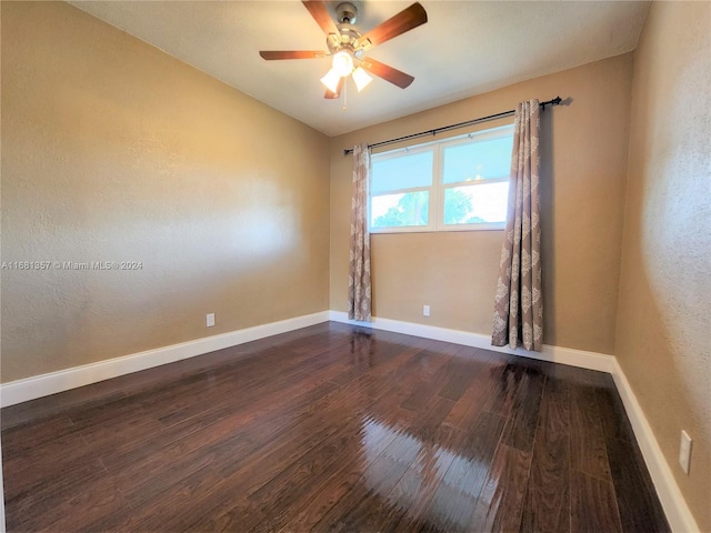 empty room featuring ceiling fan and dark hardwood / wood-style flooring